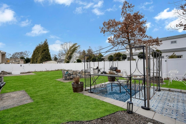 exterior space featuring outdoor dining area, a patio area, and a fenced backyard