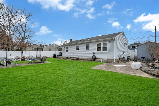 back of property featuring a patio, a yard, a chimney, and a fenced backyard