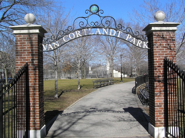 view of gate with a lawn and fence