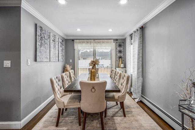 dining space with baseboards, ornamental molding, dark wood-type flooring, baseboard heating, and recessed lighting