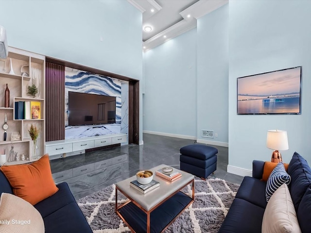 living area featuring a towering ceiling, baseboards, and recessed lighting