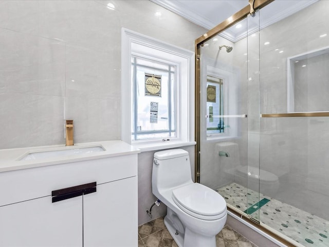 full bathroom featuring toilet, vanity, tile walls, ornamental molding, and a shower stall