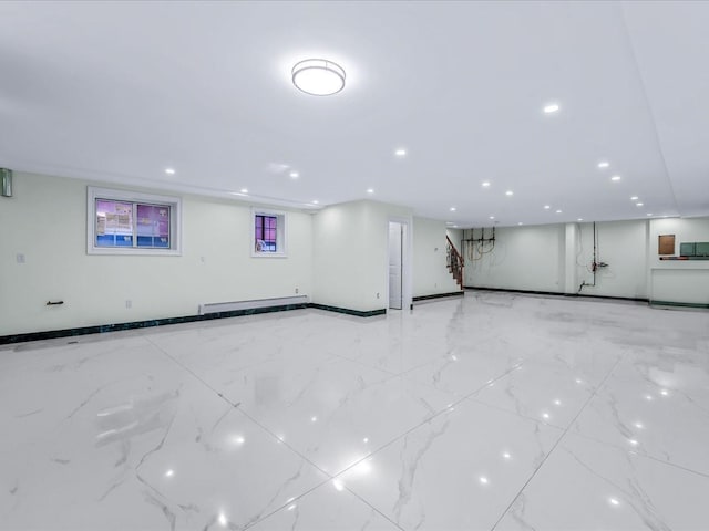 interior space with marble finish floor, baseboard heating, and recessed lighting