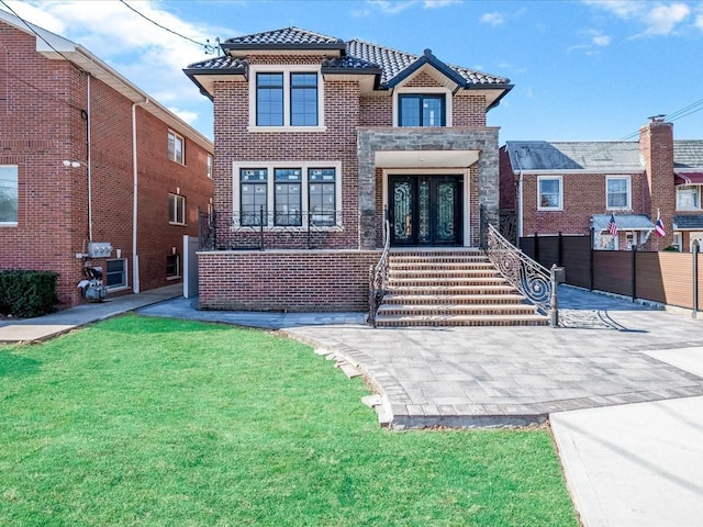 46-38 204th St, Bayside, NY 11361 - view of front of home with french doors, a tile roof, and brick siding
