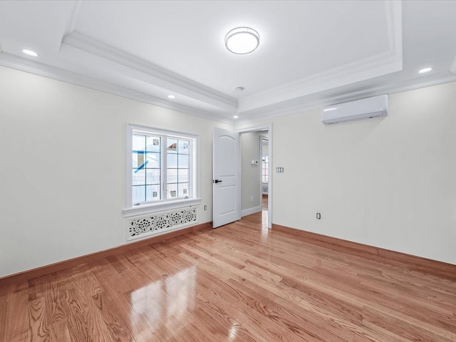 46-38 204th St, Bayside, NY 11361 - spare room with a wall mounted AC, a raised ceiling, ornamental molding, light wood-style flooring, and recessed lighting