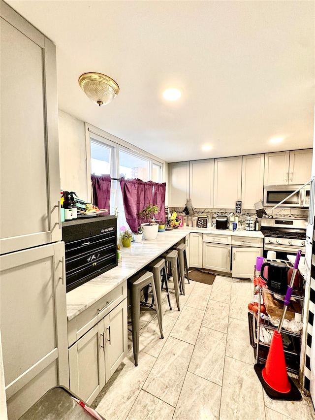 kitchen featuring stainless steel appliances and light countertops