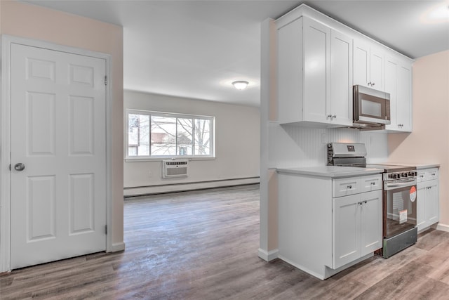 kitchen featuring a baseboard radiator, white cabinetry, light countertops, appliances with stainless steel finishes, and light wood-type flooring