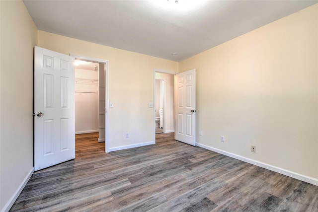 unfurnished bedroom with baseboards and wood finished floors