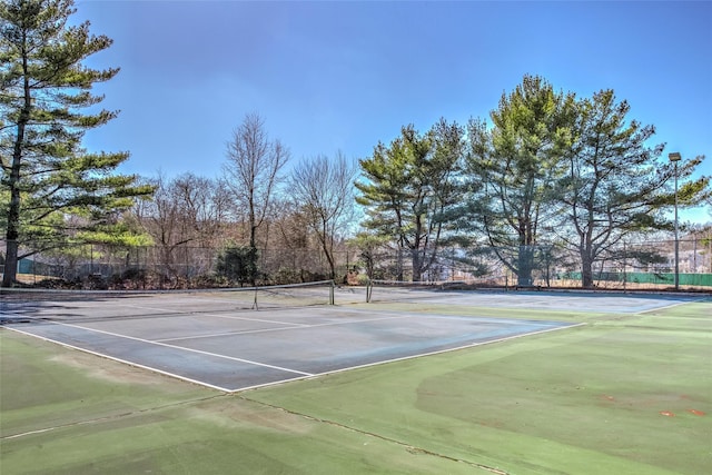 view of tennis court with fence