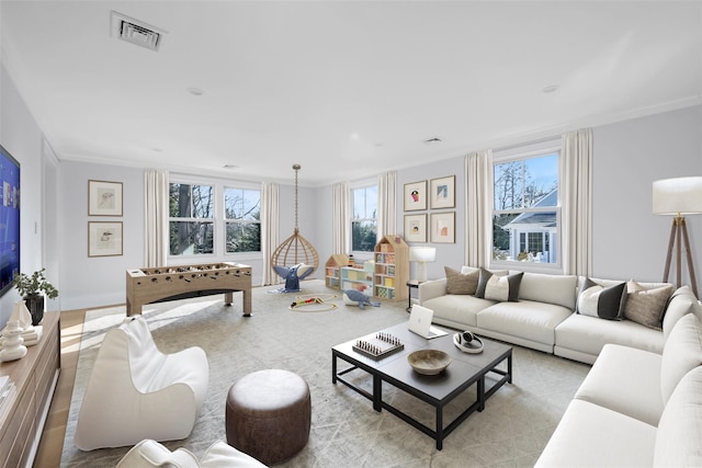 living room featuring ornamental molding and visible vents