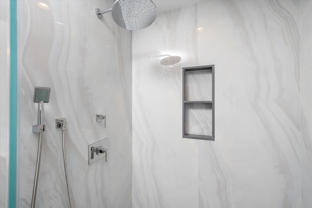 bathroom with a marble finish shower