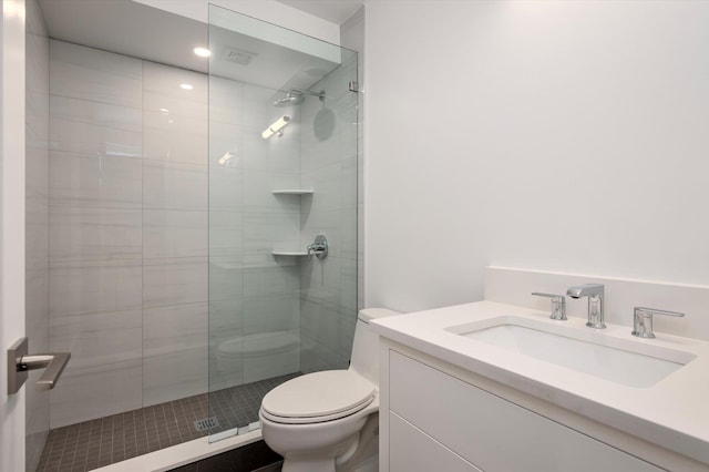 full bathroom with toilet, a stall shower, and vanity