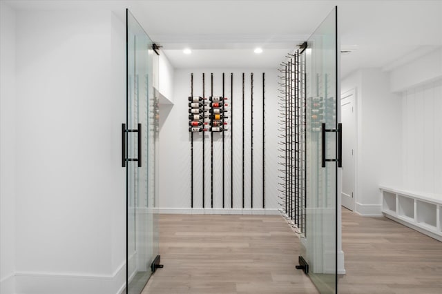 wine area featuring light wood-style flooring and recessed lighting