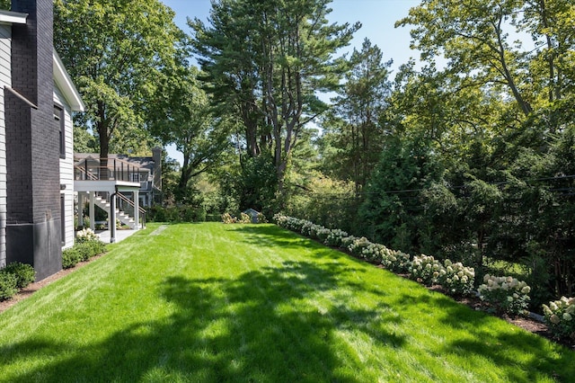 view of yard with a deck and stairway