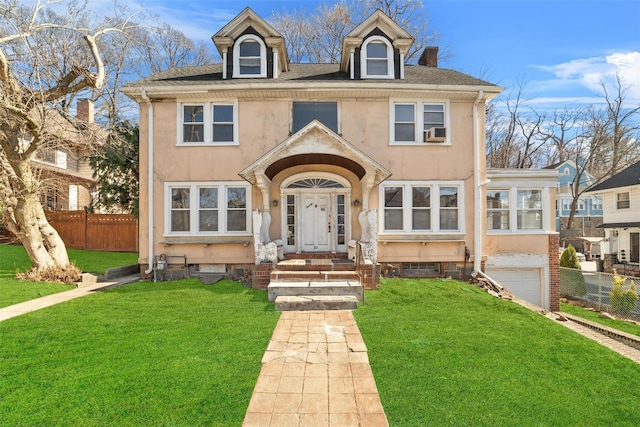 view of front of home featuring a front yard, fence, and stucco siding