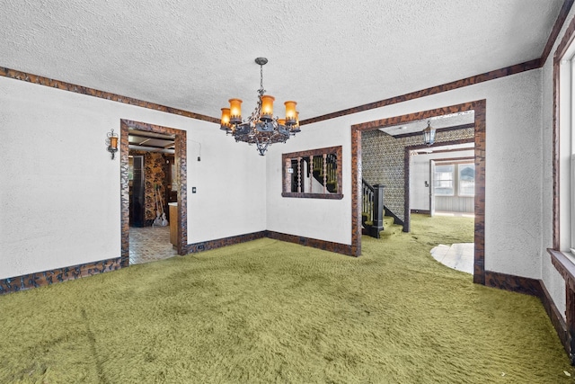 interior space featuring carpet, a notable chandelier, a textured ceiling, and baseboards