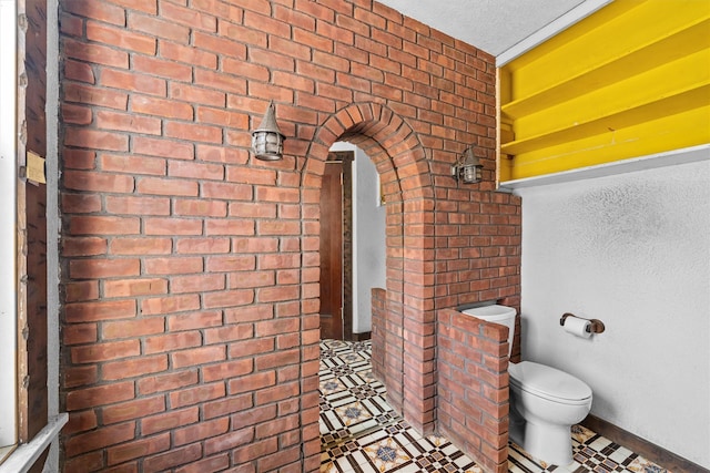 bathroom featuring a textured ceiling and toilet