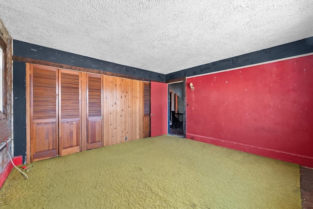 unfurnished bedroom with carpet and a textured ceiling