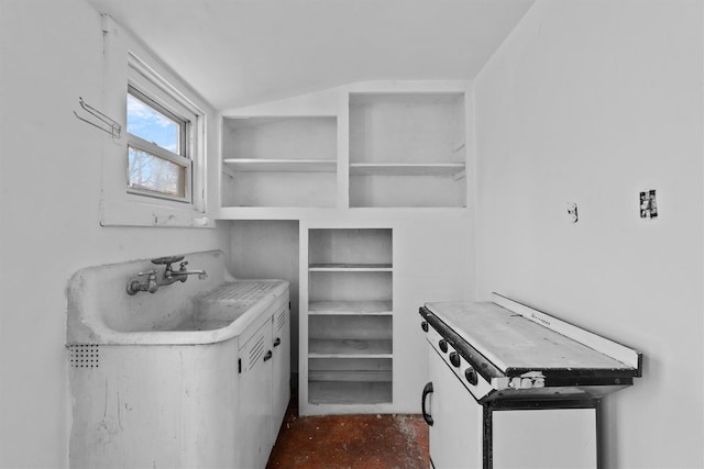 kitchen with lofted ceiling, open shelves, and light countertops