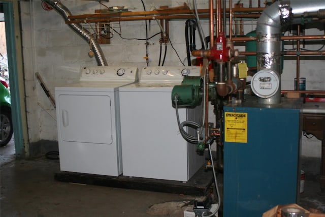 laundry room with laundry area, independent washer and dryer, and concrete block wall