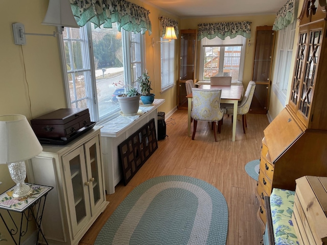 dining space with light wood-style floors and baseboards