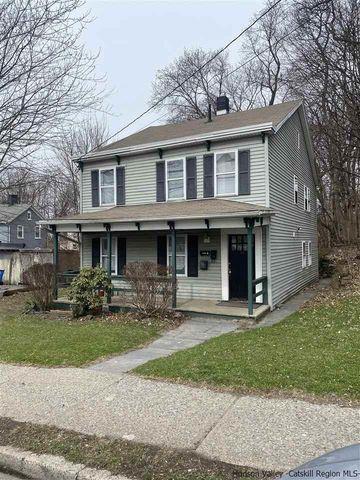 view of front facade with a chimney and a porch