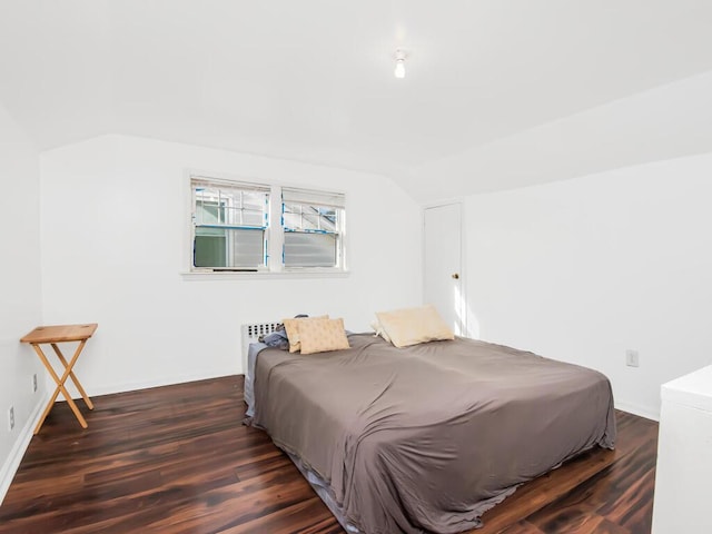 bedroom featuring vaulted ceiling and dark wood-style flooring