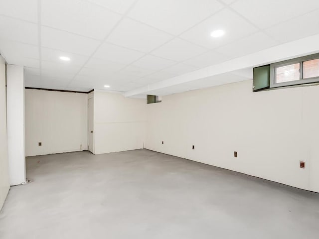 basement with a paneled ceiling and recessed lighting