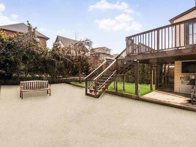 view of patio / terrace with a wooden deck and stairs