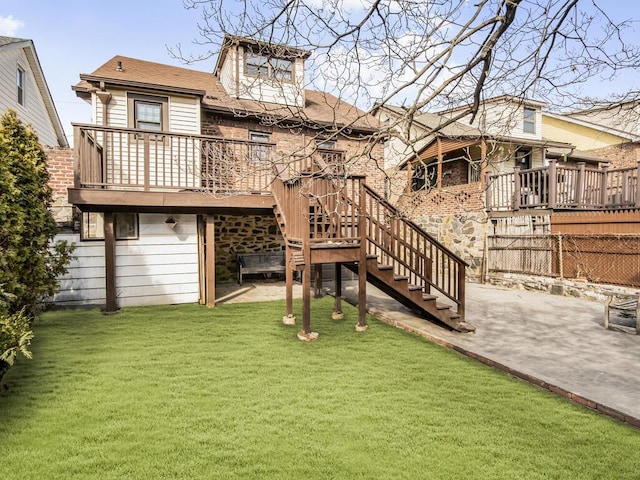 back of house featuring a yard, a patio, stairway, fence, and a deck