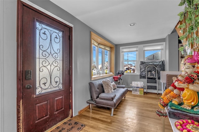 foyer featuring wood finished floors and baseboards