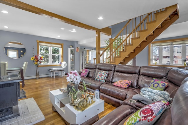 living area featuring recessed lighting, stairway, a baseboard heating unit, wood finished floors, and beamed ceiling