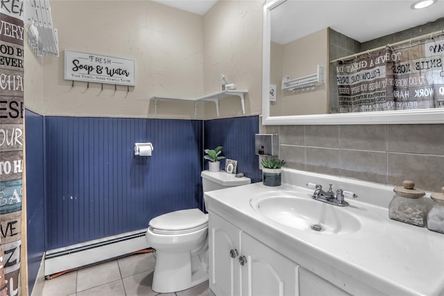 bathroom with toilet, a wainscoted wall, tile patterned floors, baseboard heating, and vanity