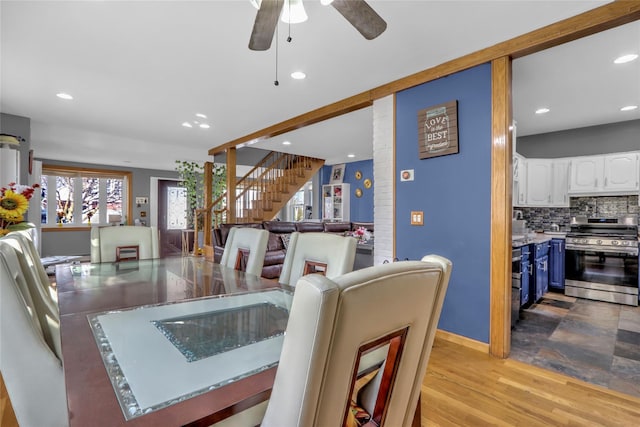 dining space with light wood finished floors, recessed lighting, ceiling fan, baseboards, and stairs