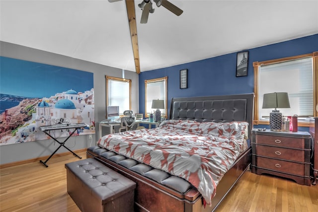 bedroom with a ceiling fan, baseboards, and wood finished floors