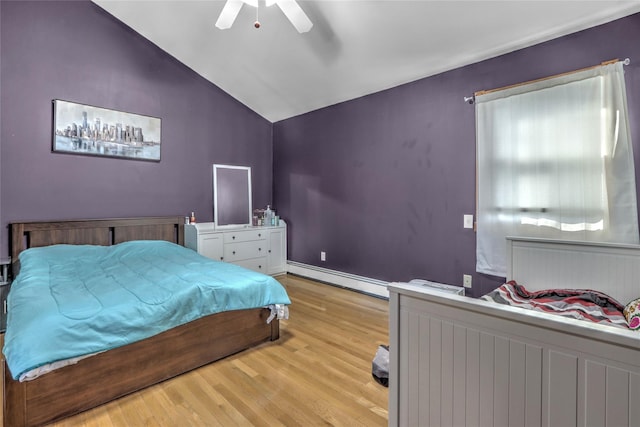 bedroom with a baseboard heating unit, ceiling fan, vaulted ceiling, and light wood-type flooring