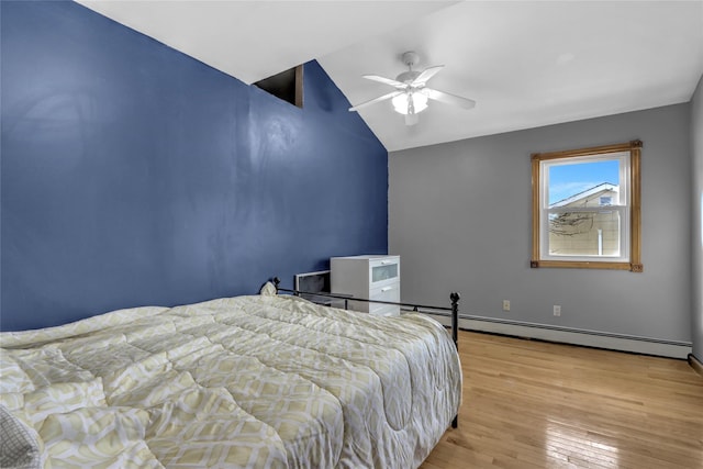 bedroom with light wood-type flooring, a baseboard radiator, vaulted ceiling, and a ceiling fan