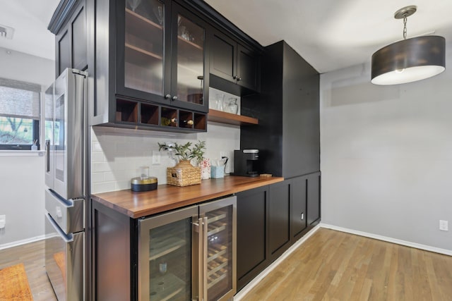 kitchen featuring tasteful backsplash, smart refrigerator, glass insert cabinets, light wood-style floors, and butcher block countertops