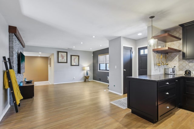 kitchen featuring light wood-style flooring, open shelves, and backsplash