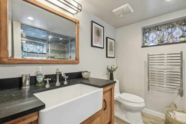 full bath with toilet, vanity, visible vents, radiator, and a stall shower