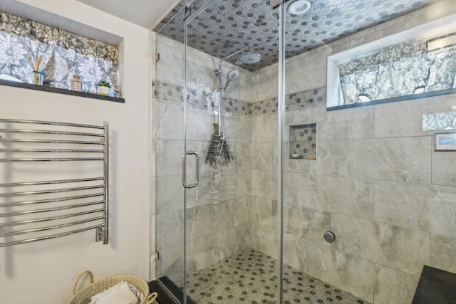 bathroom featuring radiator heating unit and a shower stall