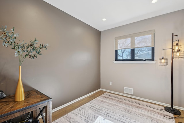 bedroom with recessed lighting, visible vents, baseboards, and wood finished floors