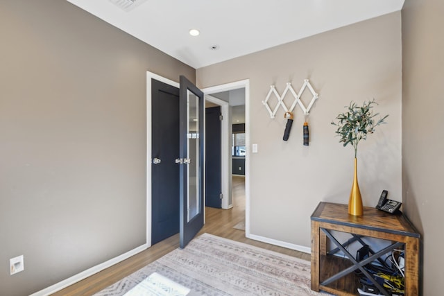 bedroom with baseboards and light wood finished floors