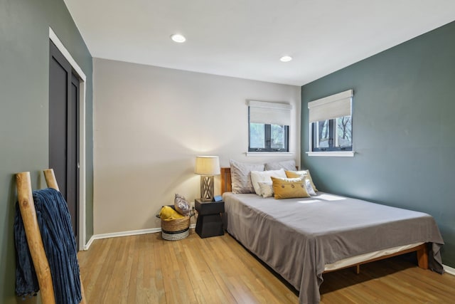 bedroom featuring light wood-type flooring, baseboards, and recessed lighting