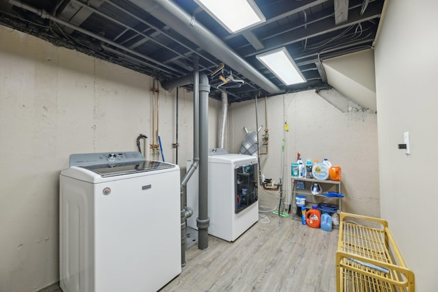 laundry area featuring laundry area, washer and dryer, and wood finished floors