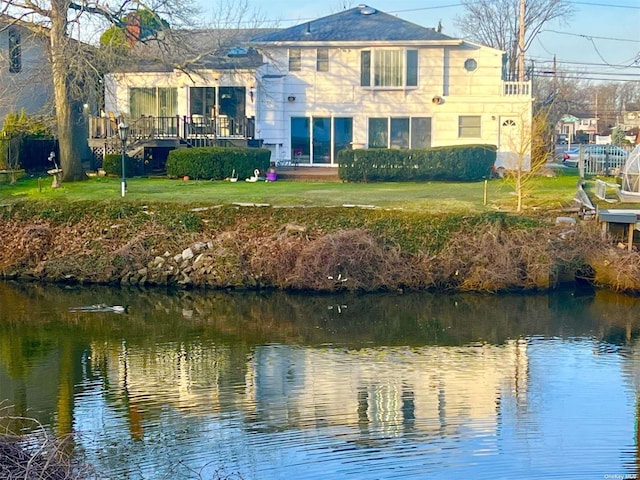 exterior space featuring a lawn and a water view