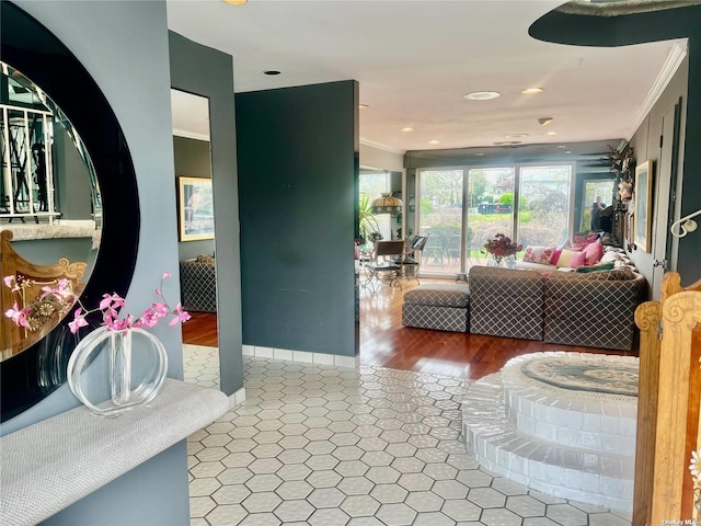 interior space with tile patterned flooring, crown molding, baseboards, and a bath