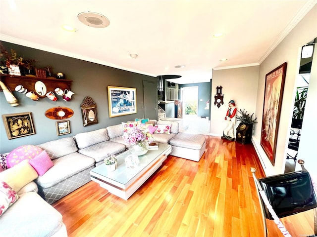 living area with light wood-style flooring and crown molding