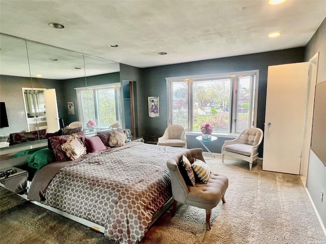 carpeted bedroom with multiple windows and baseboards