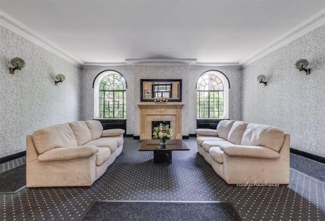 carpeted living room with a healthy amount of sunlight, a fireplace, crown molding, and wallpapered walls